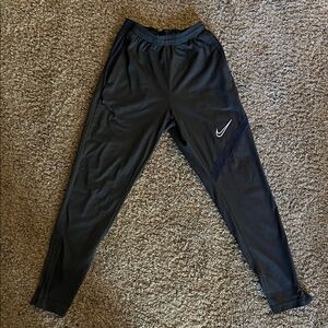 Nike Black Dri-Fit Track Pants.Item has a small flaw in the material on one leg.